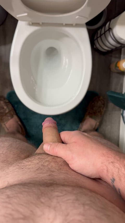 Peeing after a couple of cups of coffee before getting ready for work.